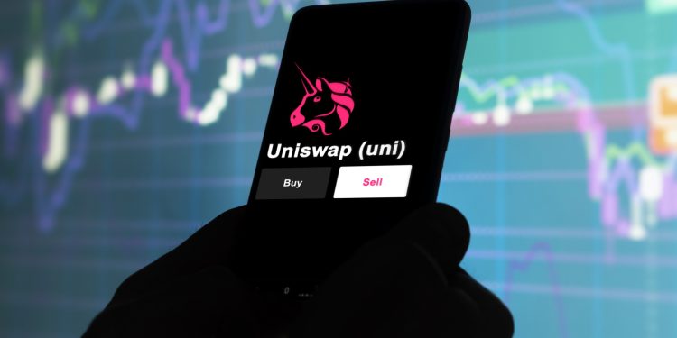 An investor's analyzing the uniswap (uni) coin on screen. A phone shows the ETF's prices to invest