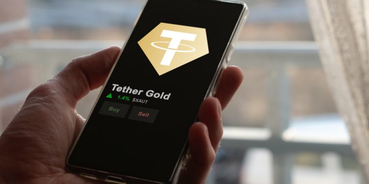 An investor analyzing the price of Tether Gold, the token coin $XAUT on a crypto exchange sreen.