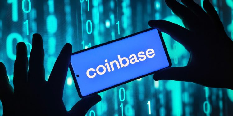 Hands holding smartphone with Coinbase app on screen