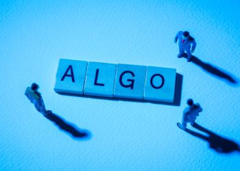 Miniature figures businessman : meeting on ALGO word by wooden block words on white paper background in blue light, ALGO or Algorand in concept of digital money, cryptocurrency and business.