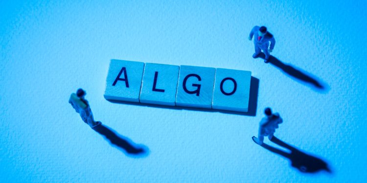 Miniature figures businessman : meeting on ALGO word by wooden block words on white paper background in blue light, ALGO or Algorand in concept of digital money, cryptocurrency and business.