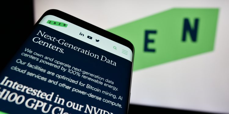 Smartphone with website of Australian Bitcoin mining company Iris Energy Ltd. (IREN) in front of logo. Focus on top-left of phone display.